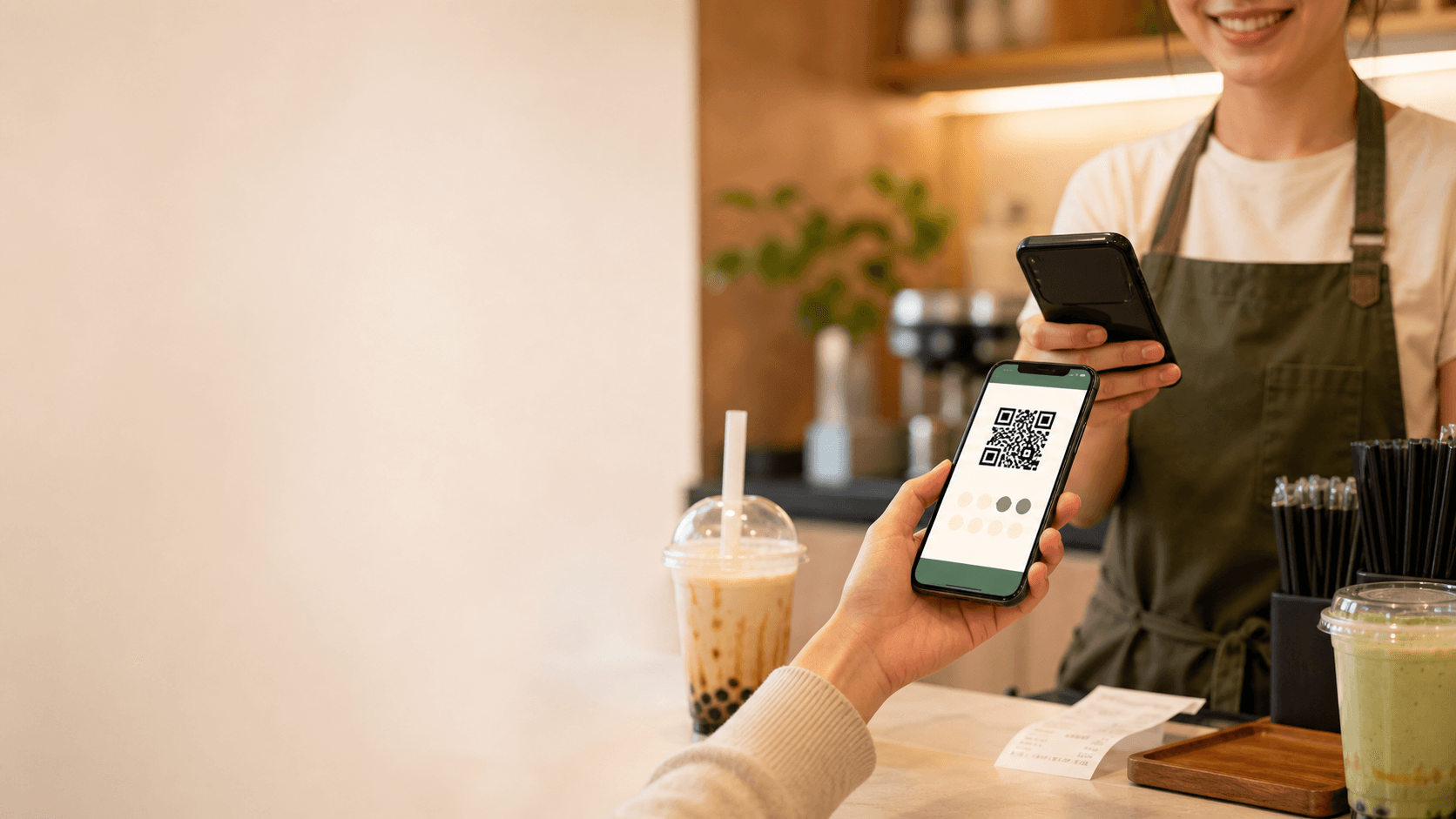 Customer showing a QR loyalty card at a small shop counter
